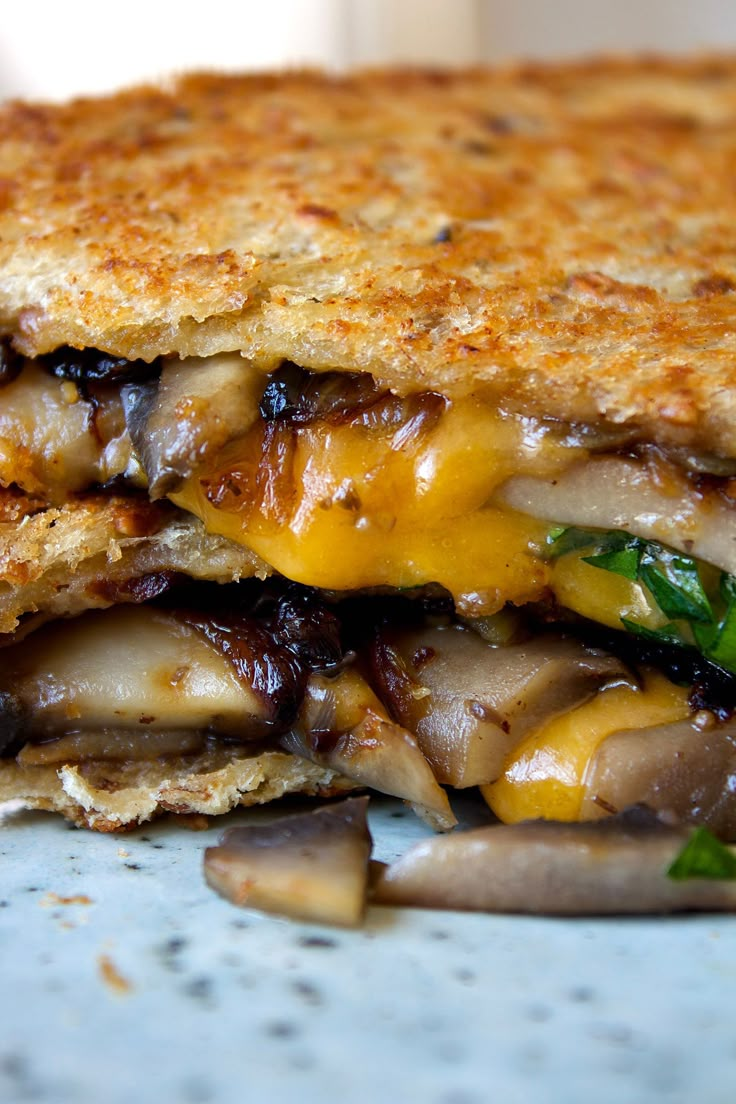 a grilled cheese and mushroom sandwich on a plate