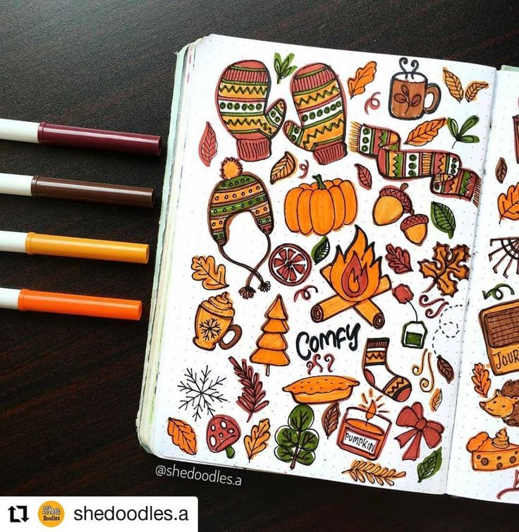 an open notebook with stickers on it next to two pencils and some markers