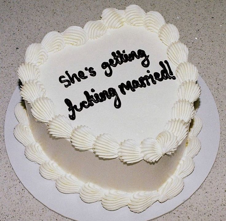 there is a white cake with black writing on it