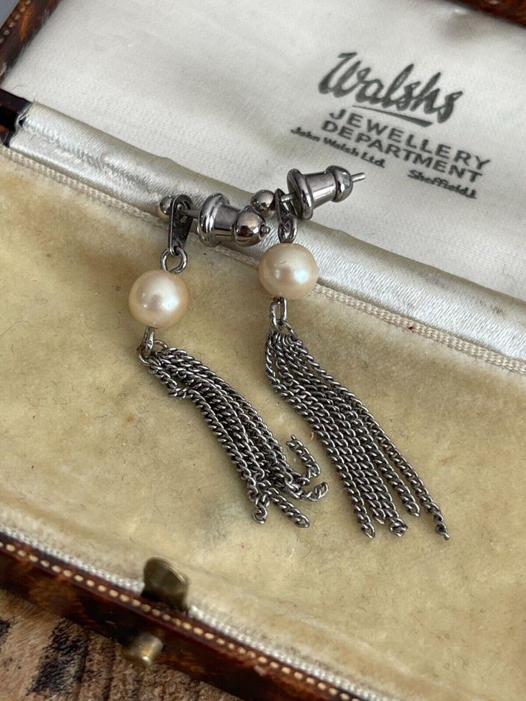 A lovely pair of drop earrings from the mid century with singular white faux pearls and chain accents.  These are fastened by a push closure and thread through the lobe.  6mm wide x 45mm long  Good condition with some light surface wear as expected with age.  Boxes aren't included.  Please study the photographs and let me know if you have questions. 👍 Dangle Earrings Silver, Drop Dangle Earrings, Silver Earrings Dangle, Earrings Silver, Faux Pearl, Jewelry Earrings Dangle, Dangle Drop Earrings, Silver Tone, Dangle Earrings