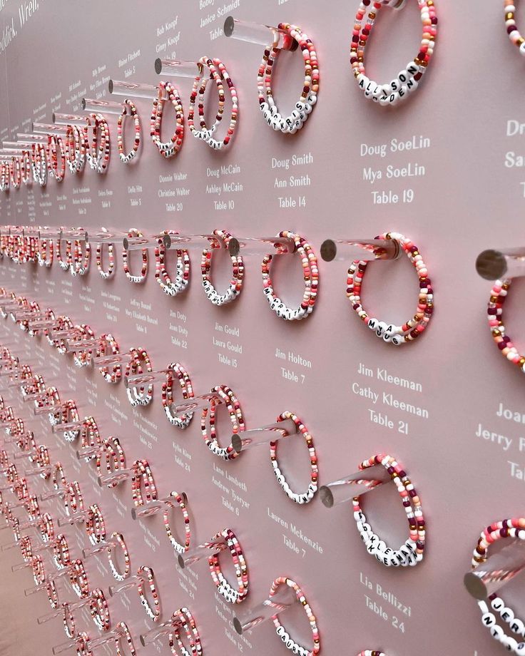 the wall is covered with pink and white beads