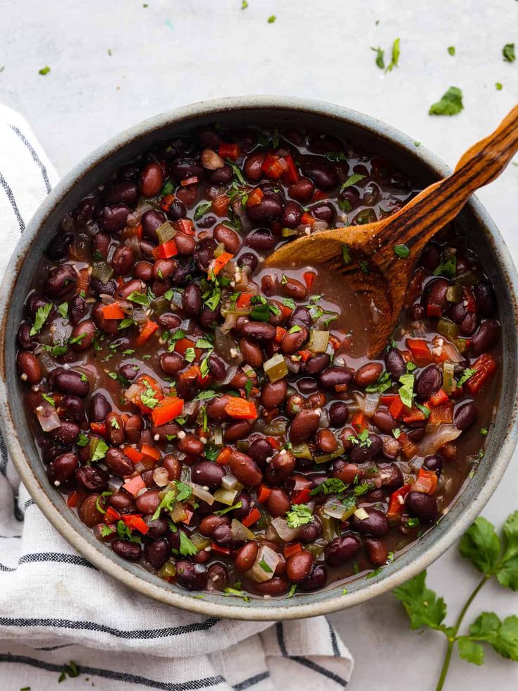 a pot filled with beans and garnished with cilantro