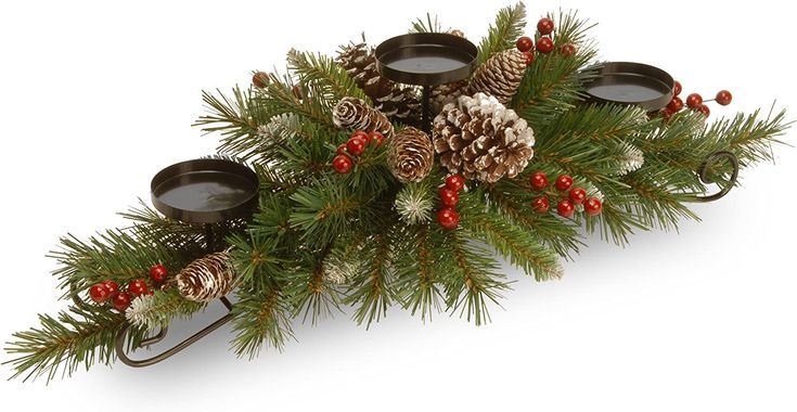 pine cones, berries and candles are arranged on a christmas tree branch with red berries