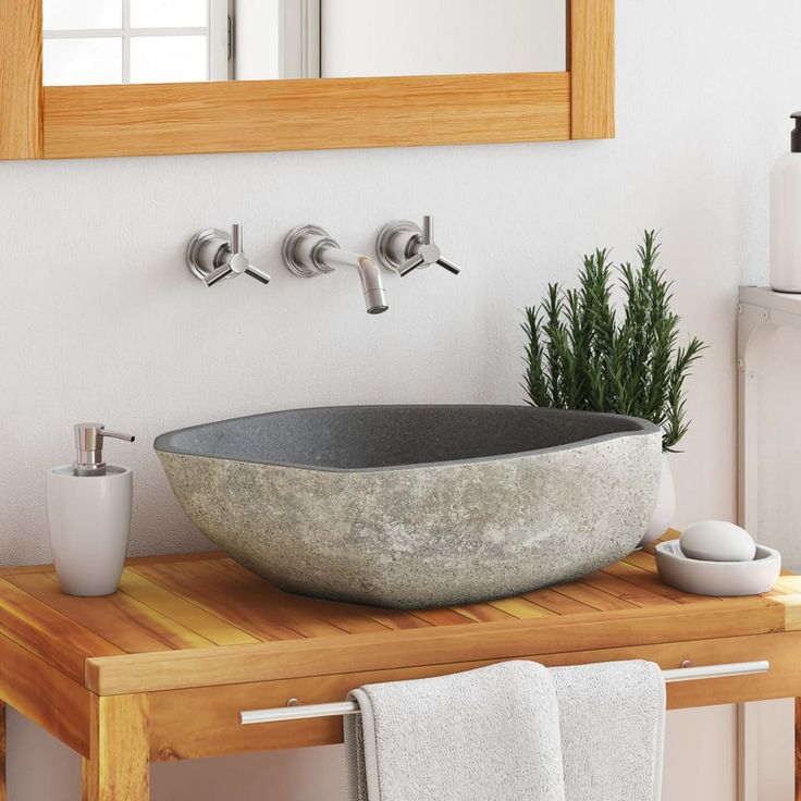 a bathroom sink sitting on top of a wooden counter