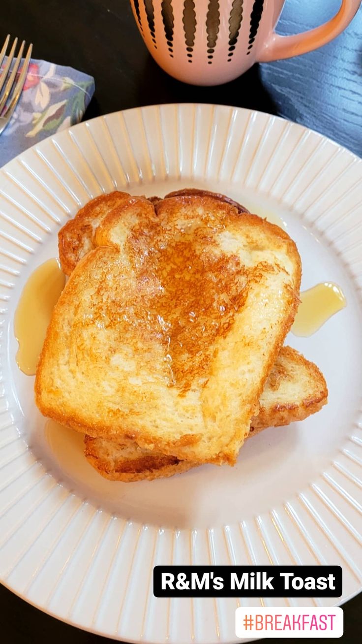 two pieces of toast sit on a plate next to a cup and fork, with the words r & m's milk toast