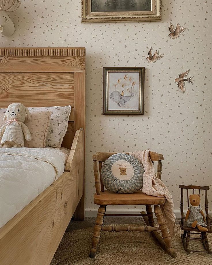 a teddy bear sitting on top of a wooden rocking chair next to a bed in a bedroom