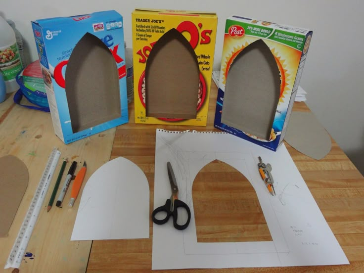 some cardboard cutouts and scissors on a table