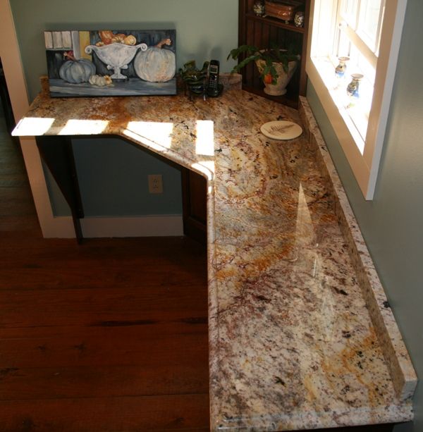 a counter top in a kitchen next to a window