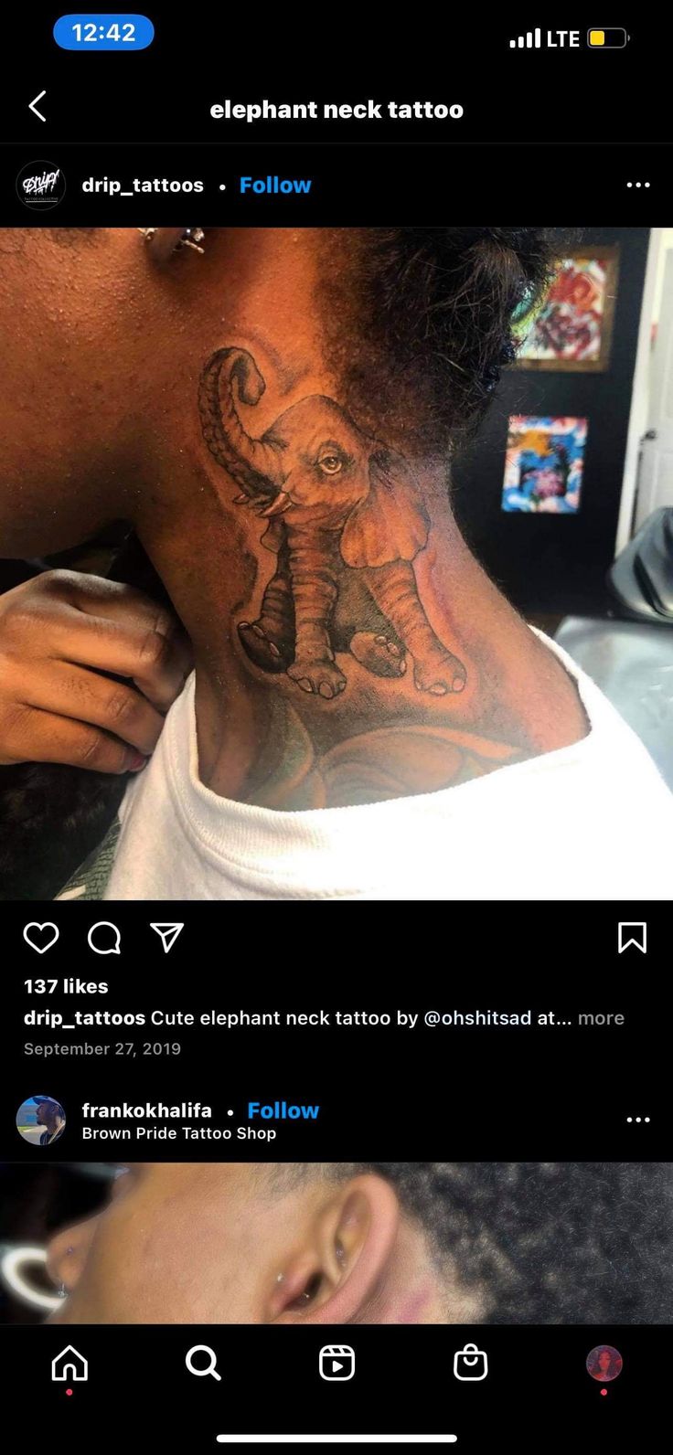 the back of a man's neck with an elephant tattoo on it