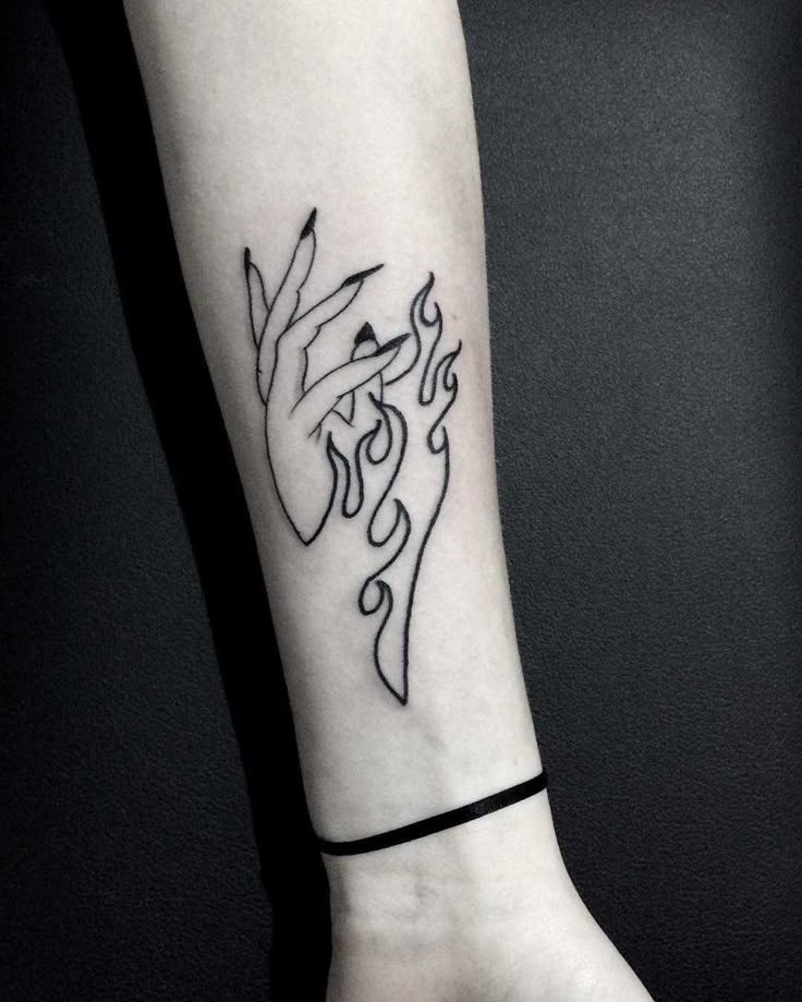 a woman's arm with a tattoo design on the left side of her wrist