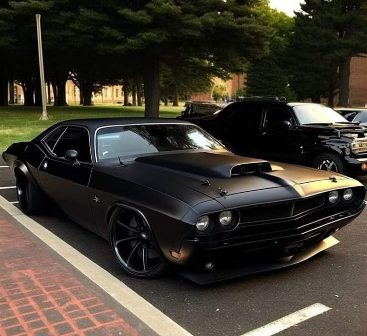 a black and gold muscle car parked in a parking lot