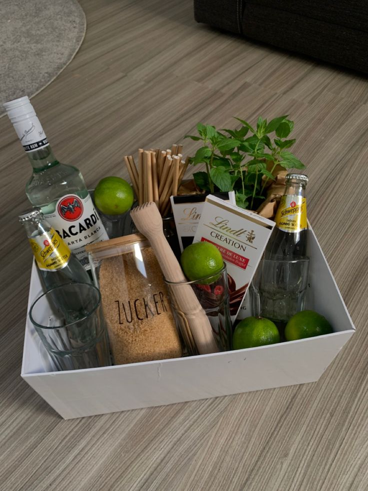 a box filled with alcohol, spices and limes