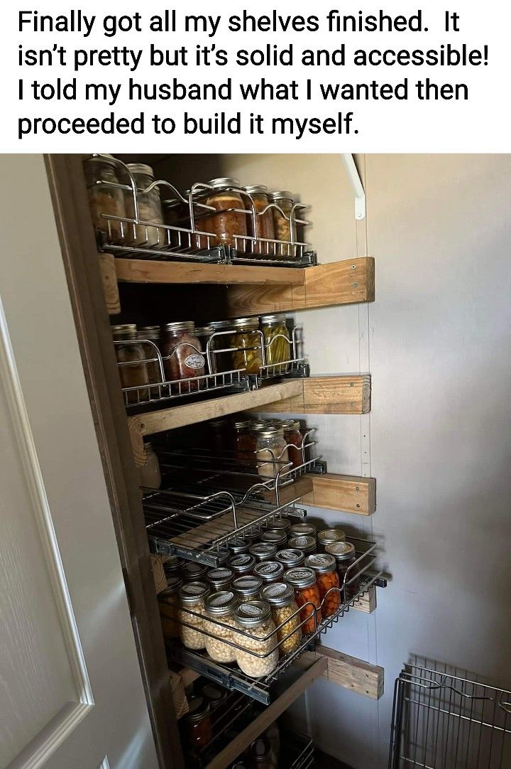 an open pantry door with shelves full of food and jars on the bottom shelfs