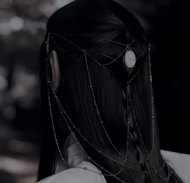 the back of a woman's head with chains attached to it