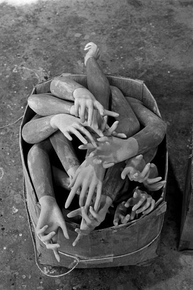 several hands reaching for something out of a box