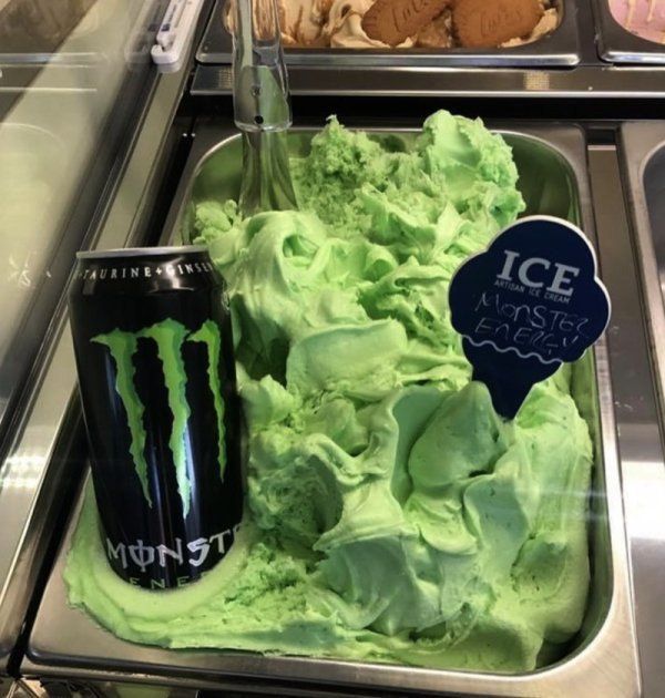 a display case filled with ice cream and green frosting next to an iced drink