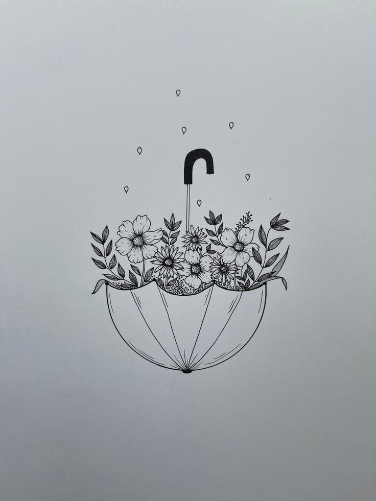 an umbrella with flowers and leaves on it is floating in the air, while raining