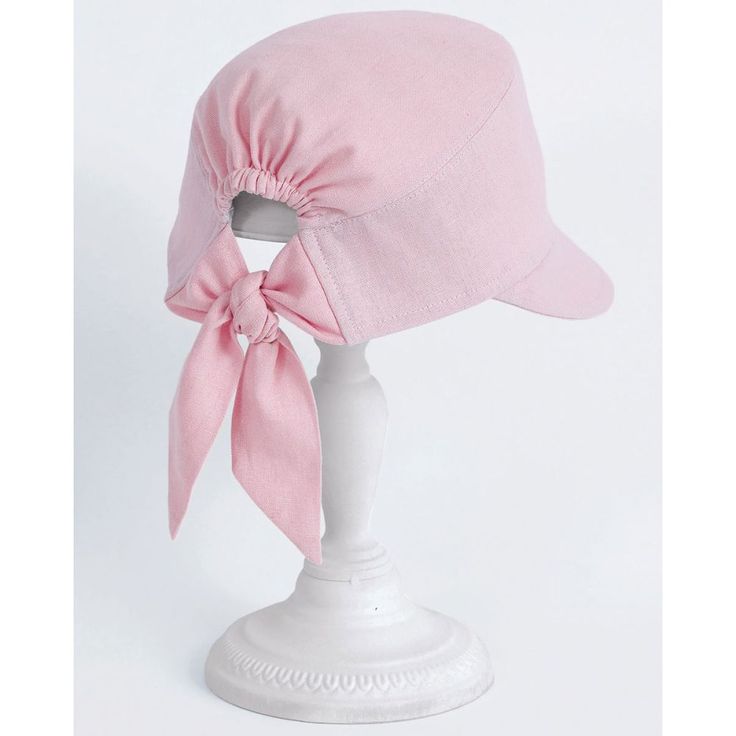 a pink hat with a bow on top