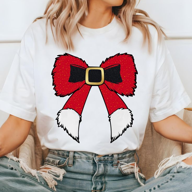 a woman wearing a white t - shirt with a red bow on it