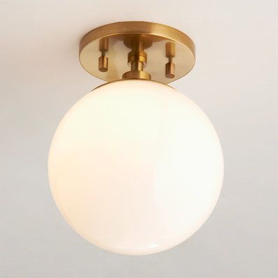 a close up of a light fixture on a ceiling with a white wall in the background