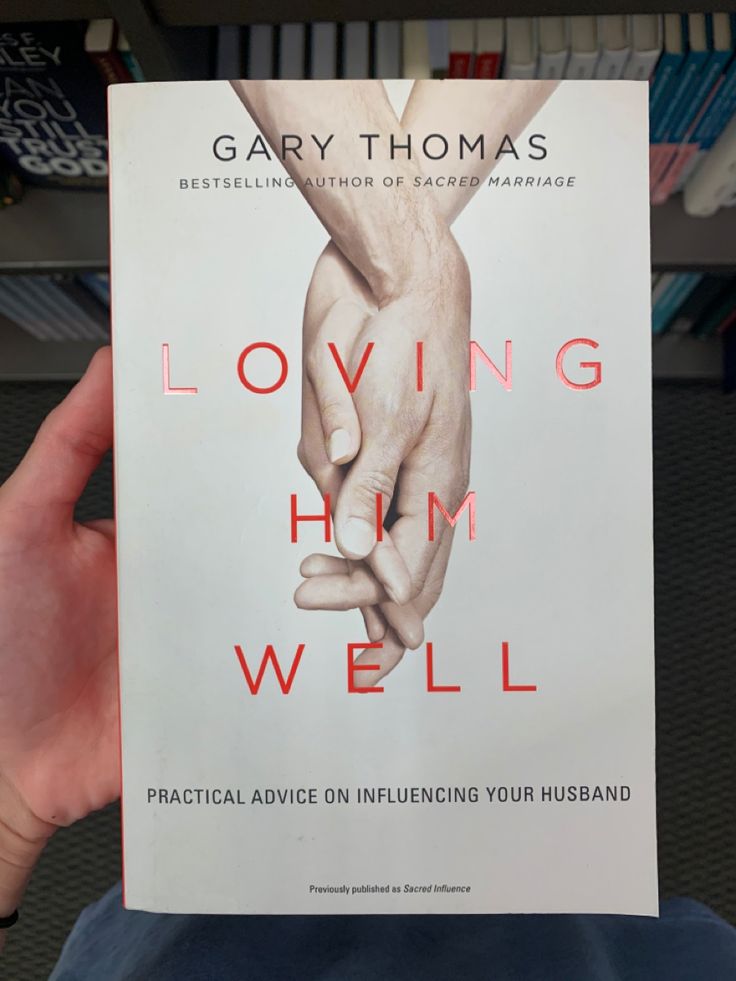 someone holding up a book about loving him well