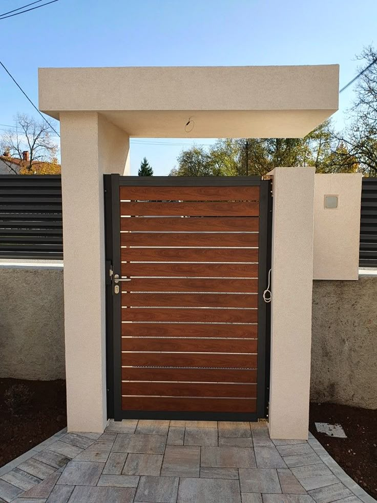 an entrance to a home with a wooden gate