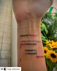 a person with a wrist tattoo that has words written in different languages on their arm