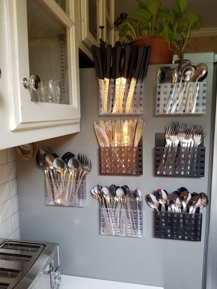 a kitchen with utensils hanging on the wall