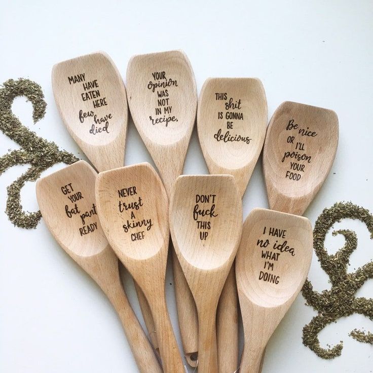 six wooden spoons with words written on them, all in different sizes and shapes