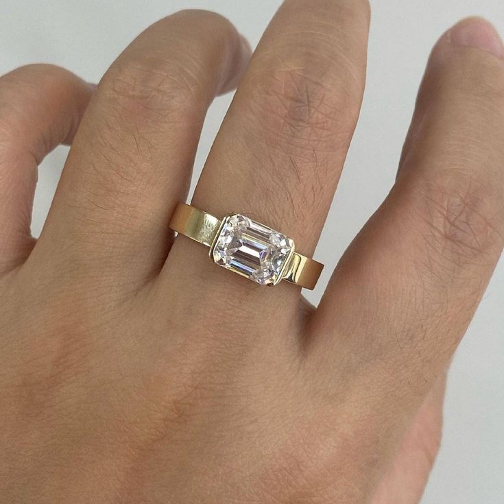 Elegant 1.0 CT Emerald Cut Engagement Ring|Half Bezel Set Ring|3 MM Flat Solitaire Band|Emerald Solitaire Ring|14k Solid Yellow Gold Jewelry ❤ ITEM DETAILS:- ✦ Brand: The American Gold House (TAGH) ✦ Handmade, high-quality item! ✦ Material: Solid 10K/14K/18K Gold, 950 Platinum and 925 Sterling Silver ✦ Diamond Type: Moissanite Diamond ✦ Diamond Cut: 7x5 MM Emerald ✦ Diamond Weight: 1.0 CT ✦ Diamond Color: Colorless ✦ Width of Band: 3.0 MM (Bottom) ✦ Diamond Clarity: VVS/VS ------------------------------------------------------------------------------ 💎 Moissanite VS Diamond 💎 ------------------------------------------------------------------------------ 👉 Moissanite Maintain Their Clarity & Sparkle Throughout A Lifetime Just Like A Diamond. 👉Moissanites Are Actually More Brilliant (Spa Emerald Bezel Engagement Ring, Marriage Vibes, Gold House, Half Bezel Setting, Solitaire Bands, Moissanite Vs Diamond, Half Bezel, Emerald Cut Engagement, Bezel Set Ring