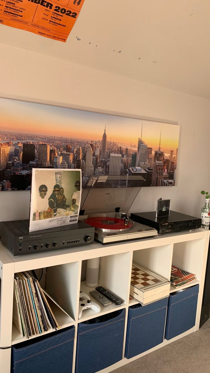 a record player sitting on top of a white shelf