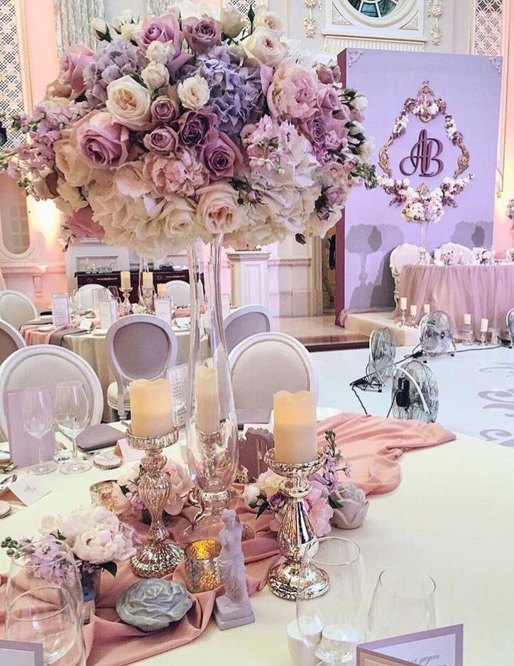 a table with flowers and candles on it