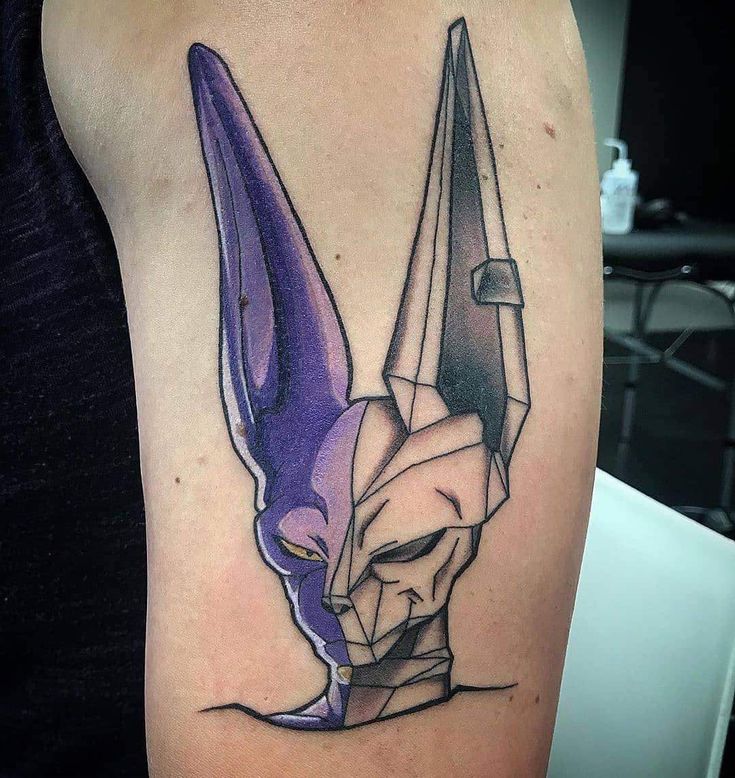 a tattoo with an origami mask on it