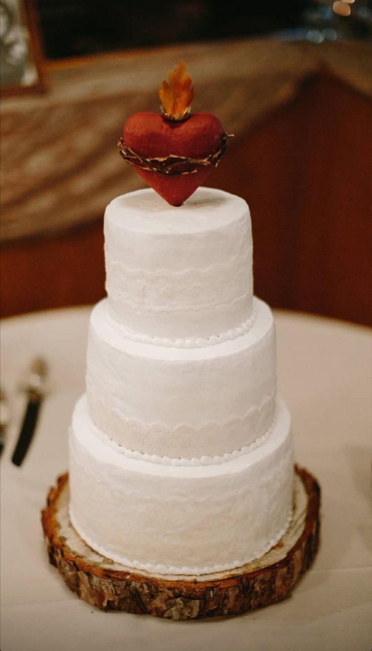 a wedding cake with a heart on top