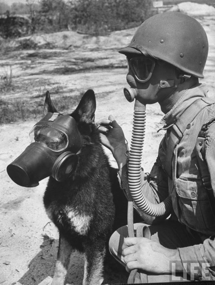 an old photo of a man with a gas mask and dog