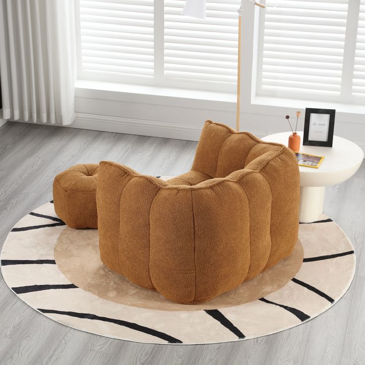 a brown chair sitting on top of a white rug