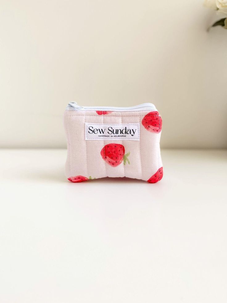 Our small quilted makeup pouch is handmade using cotton fabric.  It offers function and style and fits perfectly in your handbag while you're on the go. We recommend using it for makeup, coins and business cards and other small accessories. Featuring red strawberries on pink cotton fabric, white zipper pull and beige cotton lining. It is perfect for travel and everyday use. Dimensions of product  11cm width x 9cm height Care instructions Hand wash recommended Everyday Quilted Pouch Cosmetic Bag, Quilted Pouch Bag For Gift, Pink Quilted Bag For Gift, Trendy Coin Purse With Zipper Pocket As Gift, Quilted Pouch Bag As Gift, Fabric Bags With Zipper Pouch For Gift, Fabric Bags With Zipper Pouch As Gift, Quilted Pouch Cosmetic Bag Gift, Quilted Cosmetic Pouch Bag As Gift