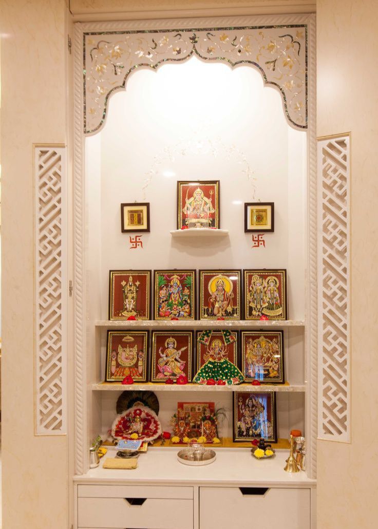 a white shelf with pictures on it in a room