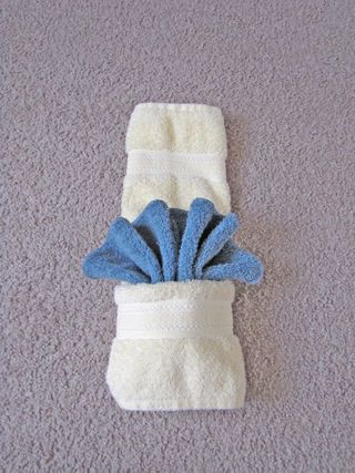 a pair of blue and white socks laying on top of a gray carpeted floor