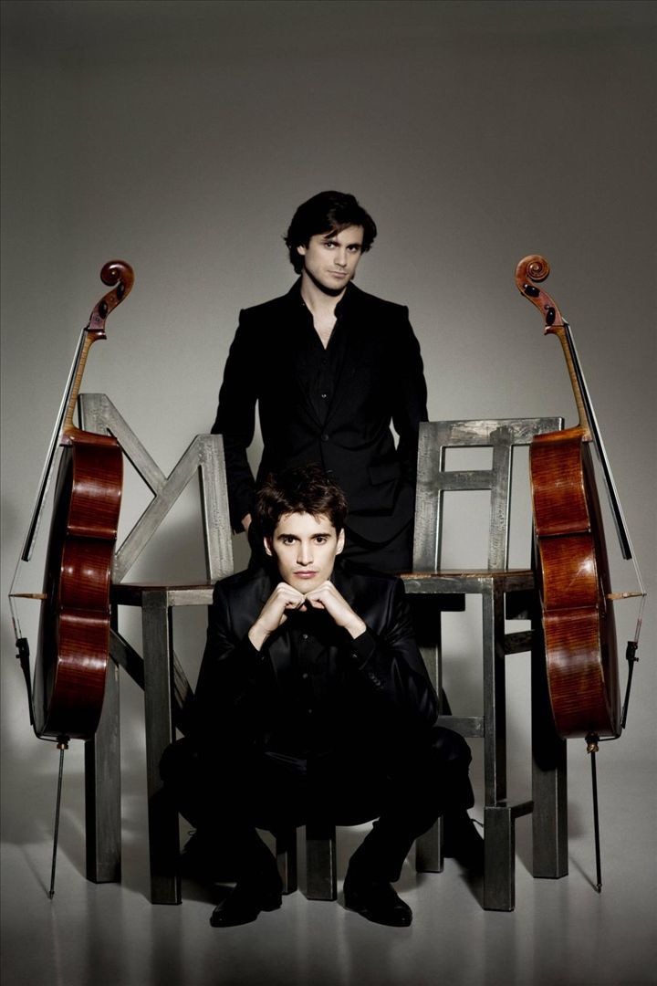 two young men sitting next to each other in front of musical instruments