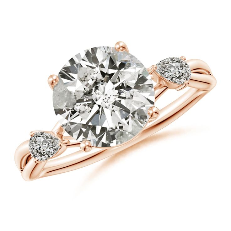 a rose gold engagement ring with three diamonds