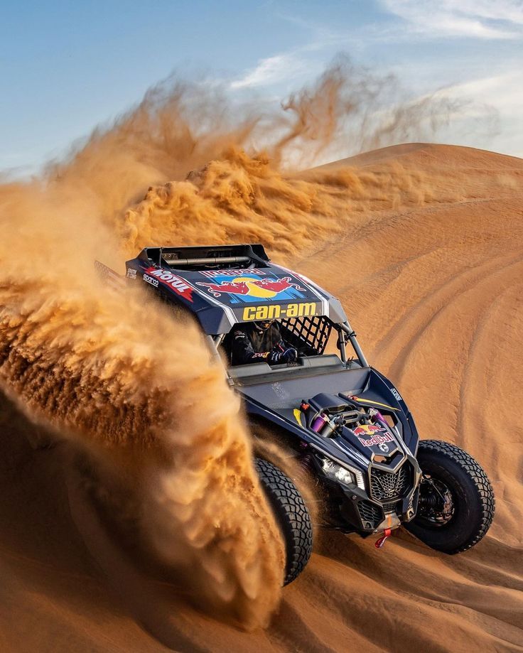 a buggy driving through the sand in the desert