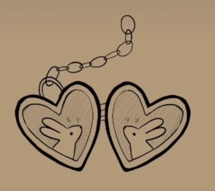 two heart shaped lockes attached to a chain with hands and feet on each side