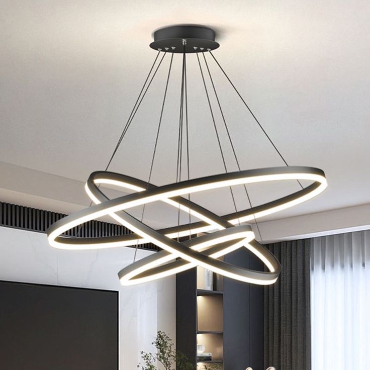 a modern chandelier hanging over a dining room table