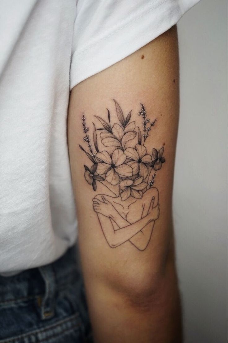 a woman's arm with flowers on it