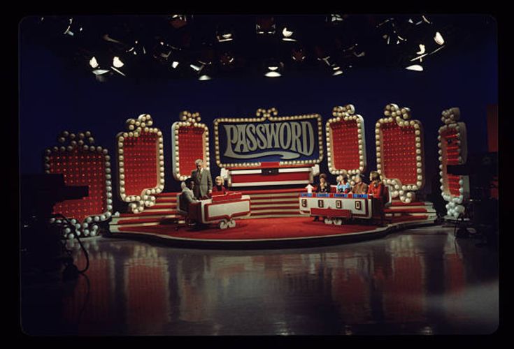 two men sitting on stage in front of a sign that says passbook with an american flag