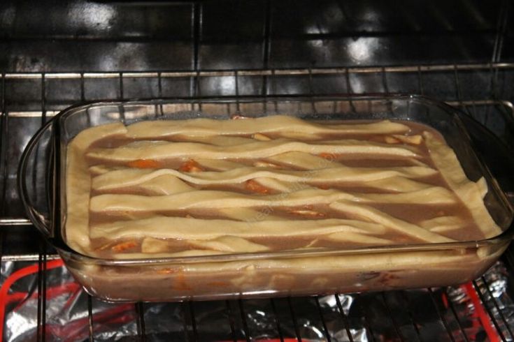 an uncooked casserole in the oven ready to be cooked and baked