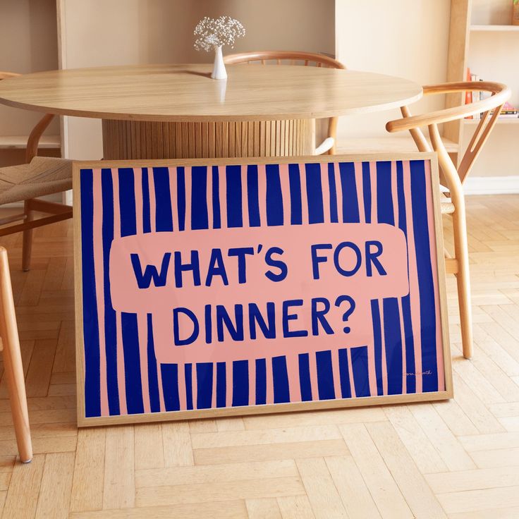 a sign that says what's for dinner? on the floor in front of a table