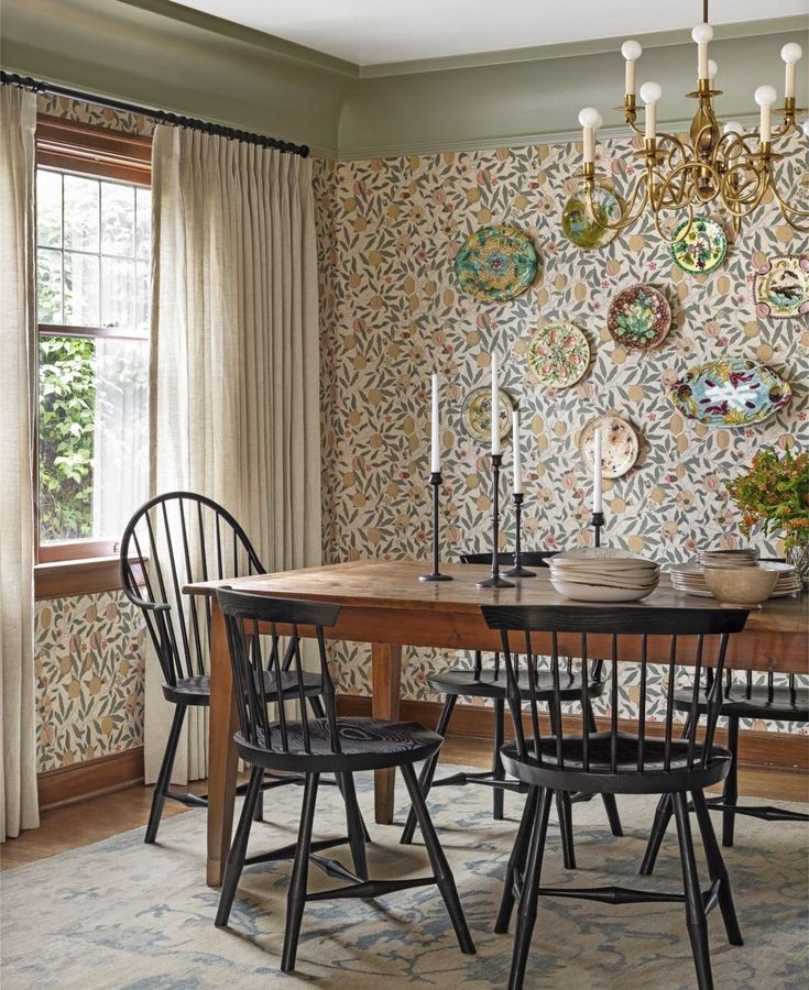 a dining room table with four chairs and a chandelier hanging from the ceiling