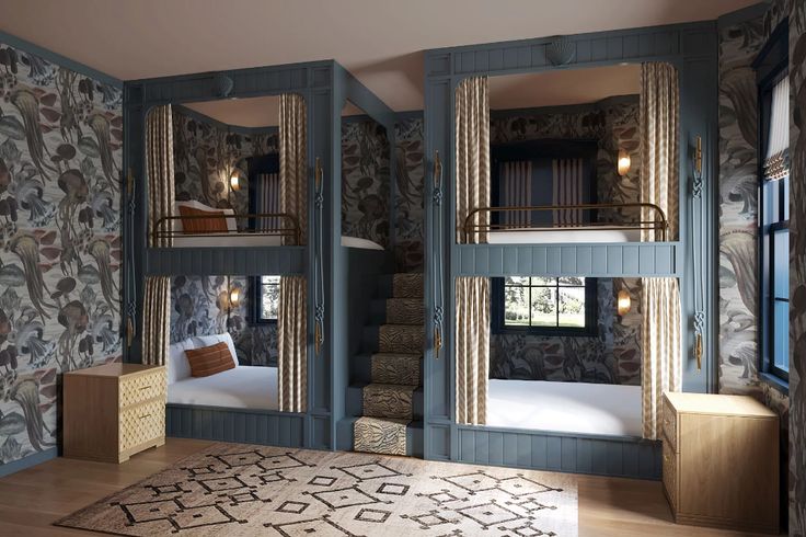 a bedroom with two bunk beds and a rug in front of the bed is decorated with floral wallpaper